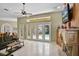 Bright living room with fireplace and french door pool access, perfect for indoor-outdoor entertaining at 1453 Langham Ter, Lake Mary, FL 32746