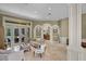 Bright living room with elegant columns, open floor plan and view into the kitchen at 1453 Langham Ter, Lake Mary, FL 32746