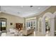 Spacious living room with neutral colors, a tile floor, and french door access to the outside at 1453 Langham Ter, Lake Mary, FL 32746