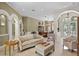 Inviting living room with elegant arches, comfortable seating, and a neutral color palette at 1453 Langham Ter, Lake Mary, FL 32746