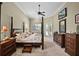 Airy main bedroom featuring a four-poster bed, large windows and plush carpet at 1453 Langham Ter, Lake Mary, FL 32746