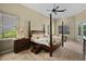 Elegant main bedroom with four-poster bed, crown molding, and serene ambiance at 1453 Langham Ter, Lake Mary, FL 32746