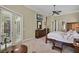 Main bedroom featuring a four-poster bed, large windows, and access to a balcony at 1453 Langham Ter, Lake Mary, FL 32746