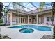 Rear view of a home with a screened pool, covered patio, and multiple access doors at 1453 Langham Ter, Lake Mary, FL 32746