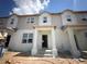 New two-story townhome featuring an open entryway, bright windows, and modern architectural details in a developing neighborhood at 15382 Burgtheater Dr, Winter Garden, FL 34787