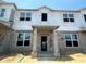 Unfinished townhome showing framing and windows with building wrap at 15382 Burgtheater Dr, Winter Garden, FL 34787