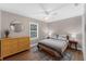 Cozy bedroom with a ceiling fan, hard wood floors and a large window at 1610 Owl Ridge Ct, Apopka, FL 32712