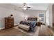 Comfortable bedroom with a ceiling fan, accent rug, and a large window for natural light at 1610 Owl Ridge Ct, Apopka, FL 32712