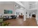 Bright and airy living room with hardwood floors, soaring ceilings, and a loft overlooking the open floor plan at 1610 Owl Ridge Ct, Apopka, FL 32712