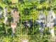 Aerial view of the property outlined in yellow, surrounded by lush greenery and neighborhood homes at 171 Cortland Ave, Winter Park, FL 32789