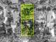Aerial view of the property outlined in yellow, surrounded by lush greenery and neighborhood homes at 171 Cortland Ave, Winter Park, FL 32789