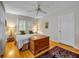 Comfortable bedroom with hardwood floors, large windows, ceiling fan, and wooden chest at 171 Cortland Ave, Winter Park, FL 32789
