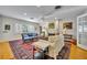 Spacious living room featuring a fireplace, hardwood floors, and built-in bookshelves at 171 Cortland Ave, Winter Park, FL 32789