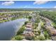A beautiful aerial view of a neighborhood next to a serene lake, with houses and green trees at 1803 Meadow Pond Way, Orlando, FL 32824