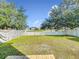 An expansive backyard enclosed by a white picket fence, providing privacy and space for outdoor enjoyment at 1803 Meadow Pond Way, Orlando, FL 32824