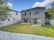 Aerial view of a home featuring a fenced backyard, well-manicured lawn, and access to the interior through sliding glass doors at 1803 Meadow Pond Way, Orlando, FL 32824