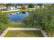 A backyard with a white picket fence and view of the lake, perfect for enjoying nature and outdoor activities at 1803 Meadow Pond Way, Orlando, FL 32824