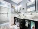 Modern bathroom features dual vessel sinks, granite countertops, and a glass-enclosed shower at 1803 Meadow Pond Way, Orlando, FL 32824