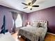 Comfortable bedroom with a ceiling fan, window, and hardwood floors at 1803 Meadow Pond Way, Orlando, FL 32824