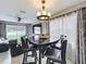 Stylish dining area featuring modern lighting, adjacent to the living area at 1803 Meadow Pond Way, Orlando, FL 32824