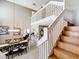 Open-concept dining area showcasing staircase access and a view of the kitchen at 1803 Meadow Pond Way, Orlando, FL 32824