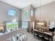 Open-concept dining area featuring views of the living room and backyard at 1803 Meadow Pond Way, Orlando, FL 32824