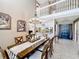 Expansive dining room with chandelier lighting, and a clear view of the foyer and modern kitchen at 1803 Meadow Pond Way, Orlando, FL 32824