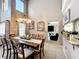 Spacious dining room showcasing a wooden table, chairs, and open layout to the living and kitchen areas at 1803 Meadow Pond Way, Orlando, FL 32824