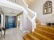 Bright entryway featuring tile floors, staircase access, and a decorative window feature at 1803 Meadow Pond Way, Orlando, FL 32824