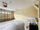 Spacious two-car garage featuring an automatic door opener and ample room for storage and parking at 1803 Meadow Pond Way, Orlando, FL 32824