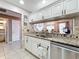 Well-appointed kitchen with granite countertops, stainless steel appliances, and a view into the living area at 1803 Meadow Pond Way, Orlando, FL 32824