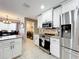 Bright kitchen featuring stainless steel appliances, granite countertops and white cabinetry at 1803 Meadow Pond Way, Orlando, FL 32824