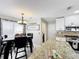 Eat-in kitchen featuring granite counters, stainless appliances and view to the dining area at 1803 Meadow Pond Way, Orlando, FL 32824