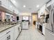 Modern kitchen featuring white cabinets, granite countertops, and stainless steel appliances at 1803 Meadow Pond Way, Orlando, FL 32824