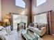 Bright living room featuring large windows, comfortable sofas, and stylish decor creating a welcoming space at 1803 Meadow Pond Way, Orlando, FL 32824