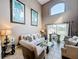 Comfortable living room highlighting high ceilings, natural light, decorative artwork and tasteful furniture at 1803 Meadow Pond Way, Orlando, FL 32824