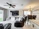 Open-concept living space with large television, cozy seating, and dining area at 1803 Meadow Pond Way, Orlando, FL 32824