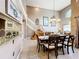 Beautifully lit Living space featuring open floorplan with staircase, kitchen view, and a dining area at 1803 Meadow Pond Way, Orlando, FL 32824