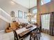 Living area with high ceilings, elegant chandelier, stairway and open design to the kitchen and Gathering rooms at 1803 Meadow Pond Way, Orlando, FL 32824