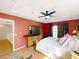 Bright main bedroom features a television, ceiling fan, and natural light from a window at 1803 Meadow Pond Way, Orlando, FL 32824