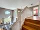 Staircase landing with open view to the living and dining areas with natural light at 1803 Meadow Pond Way, Orlando, FL 32824