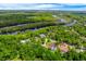 Stunning aerial view of a neighborhood surrounded by lush greenery and a winding river at 20 Twelve Oaks Trl, Ormond Beach, FL 32174