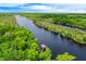 Magnificent aerial view of a wide river winding through a dense green forest at 20 Twelve Oaks Trl, Ormond Beach, FL 32174