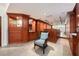 Finished basement showcasing custom wood cabinetry, a wet bar, and comfortable seating at 20 Twelve Oaks Trl, Ormond Beach, FL 32174