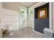 Modern bathroom with glass shower, tiled floors, and a built-in storage unit at 20 Twelve Oaks Trl, Ormond Beach, FL 32174