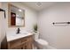 Modern bathroom with wood cabinet, white countertop, black hardware, and tile flooring at 20 Twelve Oaks Trl, Ormond Beach, FL 32174