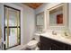 Stylish powder room featuring modern fixtures, wood ceiling, and a decorative mirror at 20 Twelve Oaks Trl, Ormond Beach, FL 32174