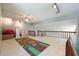 Spacious bonus room with ceiling fan, wood railing, and carpet flooring at 20 Twelve Oaks Trl, Ormond Beach, FL 32174