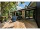 Outdoor deck area with wood flooring and furniture overlooking the surrounding area at 20 Twelve Oaks Trl, Ormond Beach, FL 32174