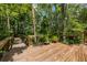 Wooden deck with railing featuring decorative plants and a path at 20 Twelve Oaks Trl, Ormond Beach, FL 32174